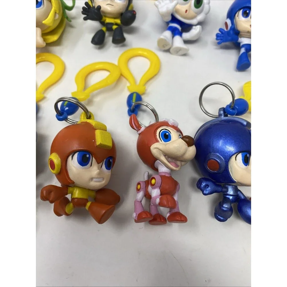 lot of 9 CAPCOM MEGA MAN BACKPACK HANGERS METALLIC FIRE MAN JUST TOYS INTL.